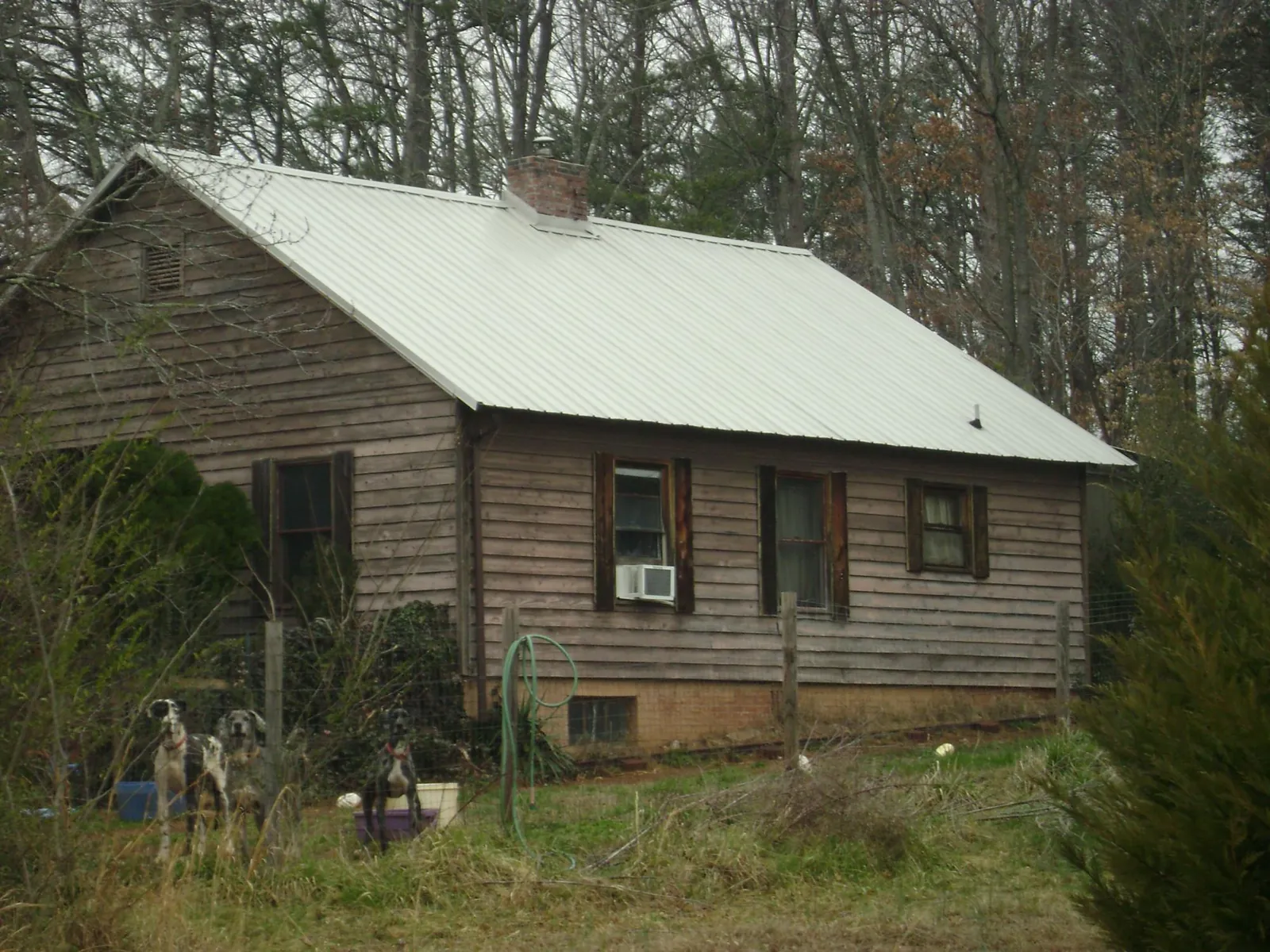 White metal roof on an old wood sided farmhouse, from a Asphalt Shingle Roof Repair job in Franklin